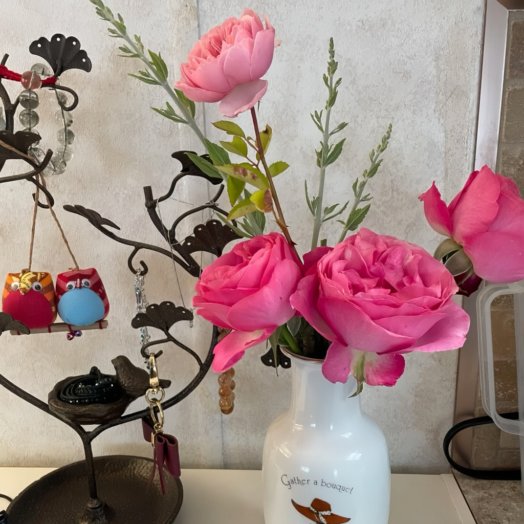 All Dressed Up roses in a vase arrangement with other fresh-cut flowers on a tabletop
