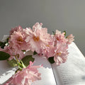 Freshly cut Couture Rose Tilia roses arranged in a glass vase, highlighting their form and fragrance.