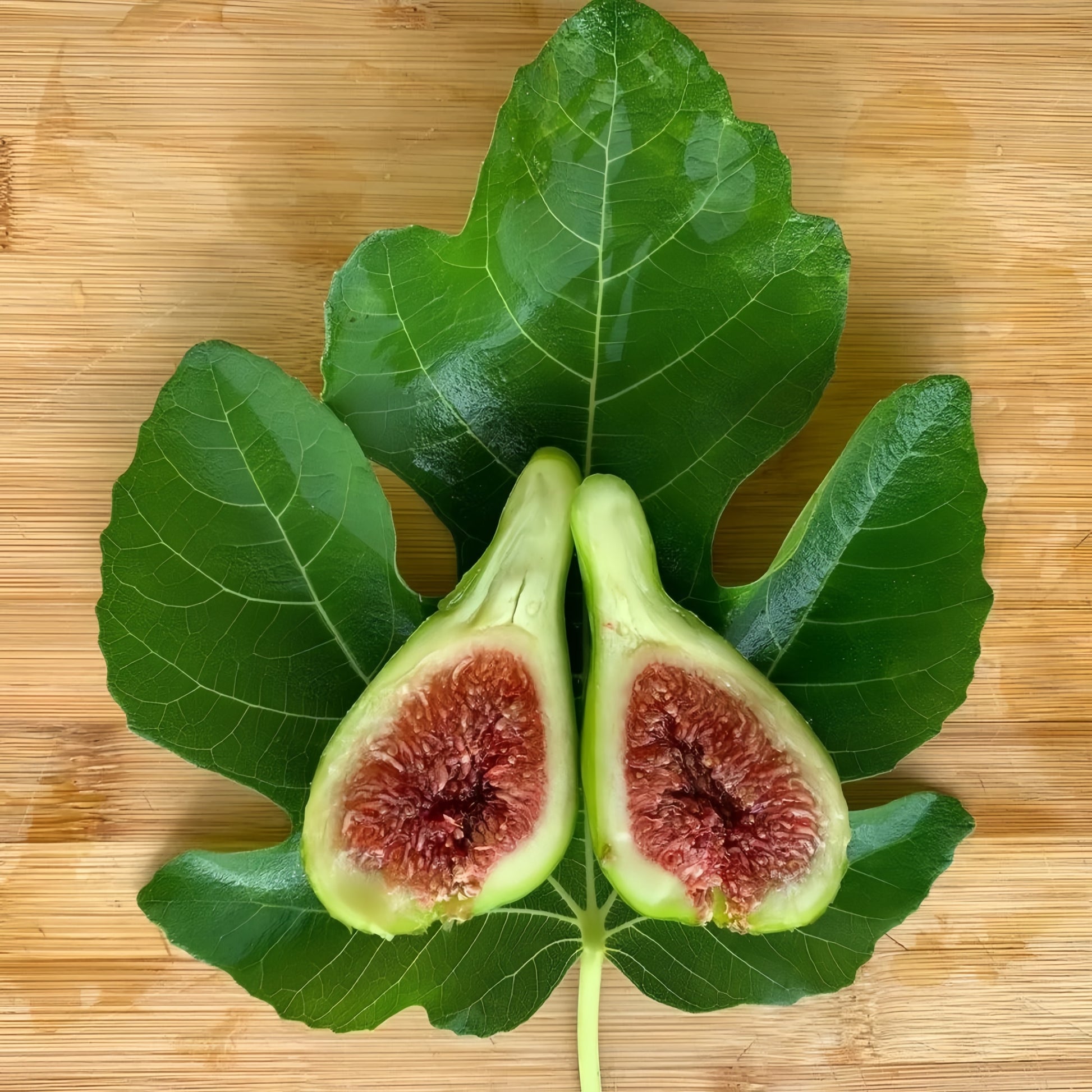Freshly cut White Adriatic Fig with vibrant strawberry-colored interior.